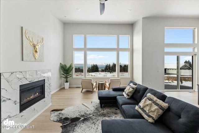 1029 Shelley Ave, Homer, AK 99603 - living room featuring wood finished floors, ceiling fan, and a fireplace