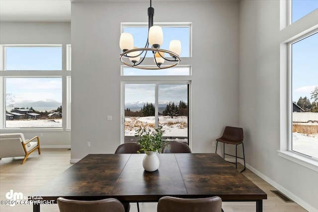 1029 Shelley Ave, Homer, AK 99603 - dining area with a chandelier, light wood-style floors, and a towering ceiling