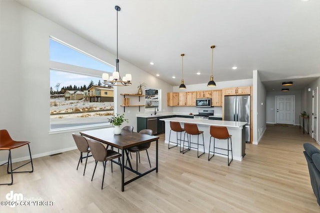 1029 Shelley Ave, Homer, AK 99603 - dining space with light wood-style floors, a chandelier, lofted ceiling, and recessed lighting