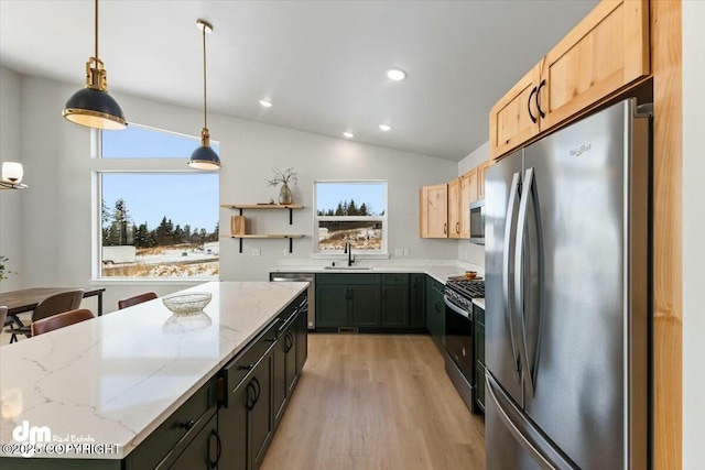 1029 Shelley Ave, Homer, AK 99603 - kitchen featuring appliances with stainless steel finishes, light wood-type flooring, healthy amount of natural light, light stone counters, and vaulted ceiling