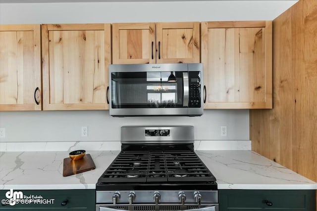 1029 Shelley Ave, Homer, AK 99603 - kitchen featuring appliances with stainless steel finishes, light brown cabinetry, and light stone counters