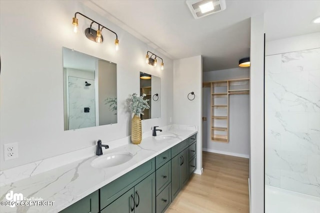 1029 Shelley Ave, Homer, AK 99603 - full bath featuring double vanity, a marble finish shower, wood finished floors, and a spacious closet