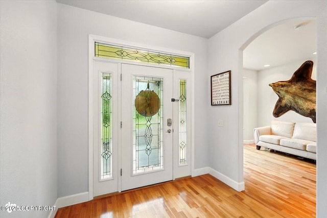 3361 N Inspiration Loop, Wasilla, AK 99654 - entrance foyer with arched walkways, light wood-style floors, and baseboards