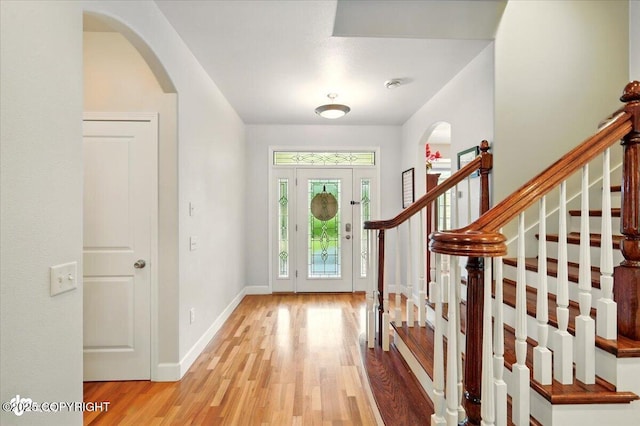 3361 N Inspiration Loop, Wasilla, AK 99654 - foyer with light wood-style floors, arched walkways, baseboards, and stairs
