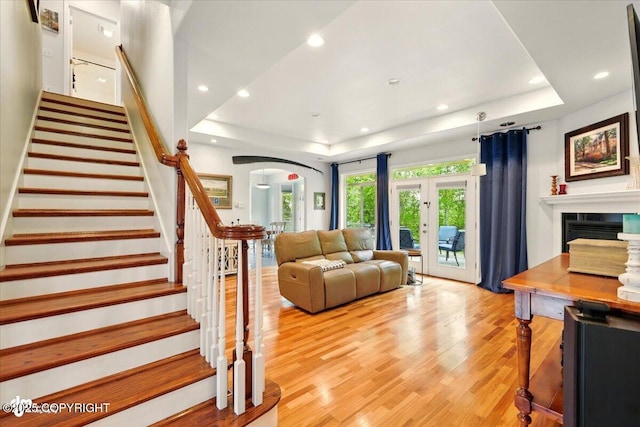 3361 N Inspiration Loop, Wasilla, AK 99654 - living area with a raised ceiling, light wood-style flooring, recessed lighting, stairway, and arched walkways