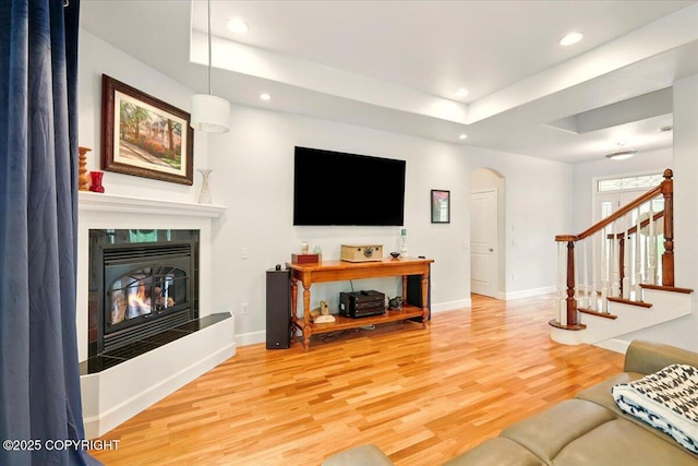 3361 N Inspiration Loop, Wasilla, AK 99654 - living area featuring arched walkways, wood finished floors, recessed lighting, baseboards, and stairway
