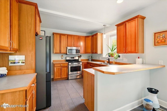 3361 N Inspiration Loop, Wasilla, AK 99654 - kitchen featuring stainless steel appliances, a peninsula, a sink, and light countertops
