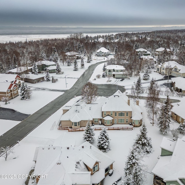 snowy aerial view with a residential view