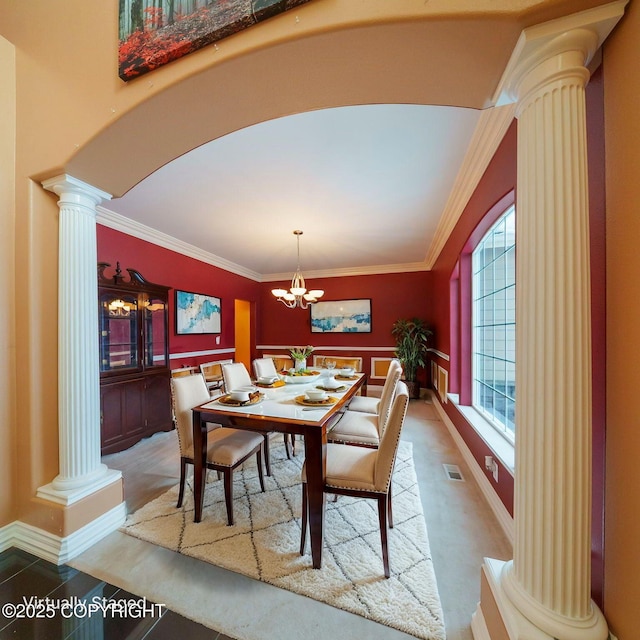 dining area with ornate columns, arched walkways, ornamental molding, visible vents, and a notable chandelier