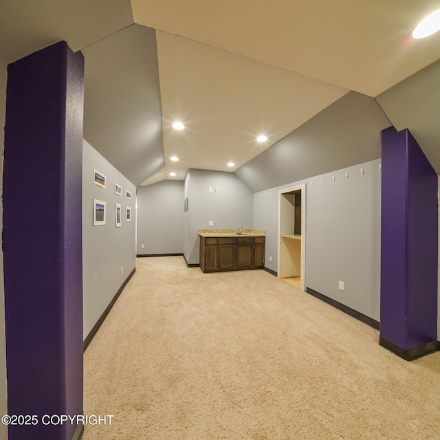 bonus room with baseboards, light carpet, recessed lighting, lofted ceiling, and a sink