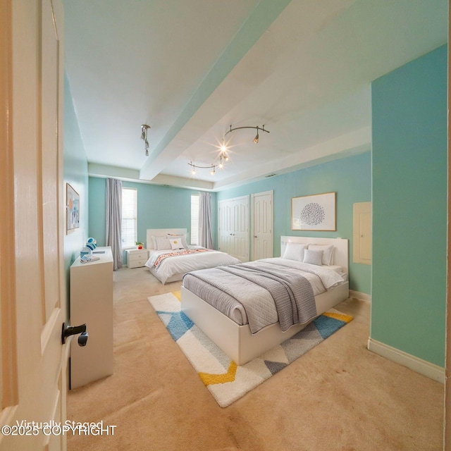 carpeted bedroom featuring beamed ceiling, baseboards, and track lighting