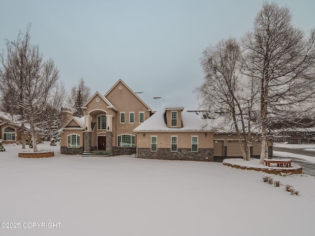 traditional home featuring an outdoor structure, stone siding, and a garage