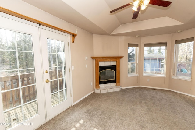 10127 Crest View Ln, Eagle River, AK 99577 - unfurnished living room featuring ceiling fan, a tray ceiling, carpet flooring, a tiled fireplace, and baseboards