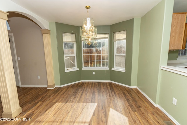10127 Crest View Ln, Eagle River, AK 99577 - unfurnished dining area with visible vents, baseboards, arched walkways, an inviting chandelier, and wood finished floors