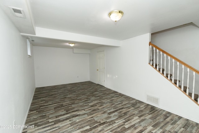 10127 Crest View Ln, Eagle River, AK 99577 - finished basement with wood finished floors, visible vents, and stairway