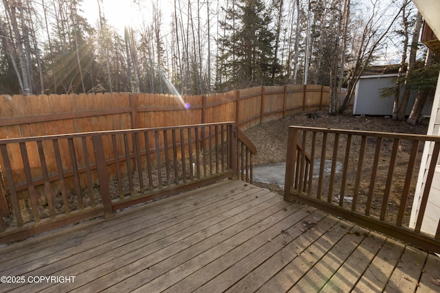 10127 Crest View Ln, Eagle River, AK 99577 - deck featuring an outbuilding, a fenced backyard, and a storage shed
