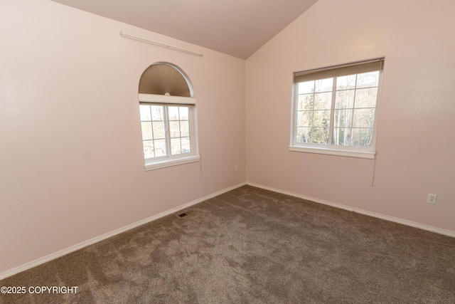10127 Crest View Ln, Eagle River, AK 99577 - empty room with visible vents, dark colored carpet, and lofted ceiling