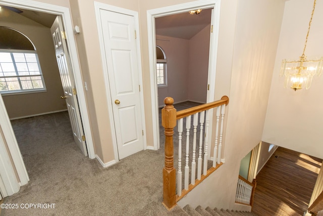 10127 Crest View Ln, Eagle River, AK 99577 - hall with a chandelier, carpet flooring, baseboards, and an upstairs landing