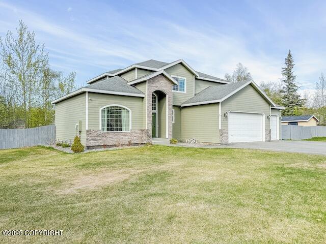 2731 E Tamarak Ave, Wasilla, AK 99654 - view of front of property with an attached garage, driveway, and a shingled roof