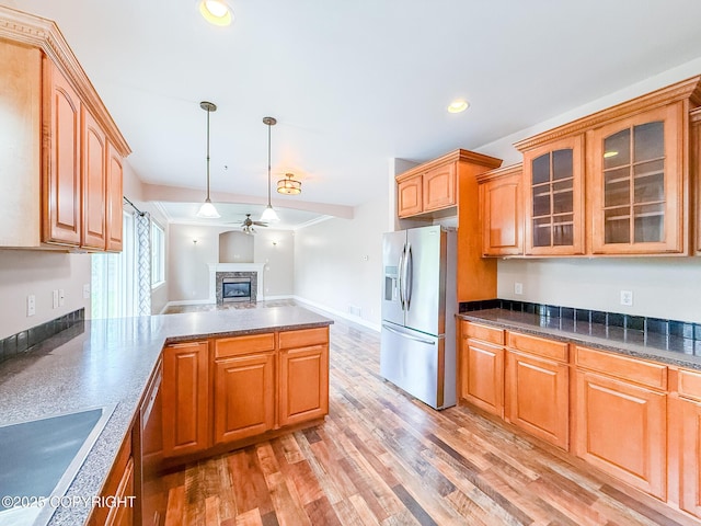 2731 E Tamarak Ave, Wasilla, AK 99654 - kitchen featuring appliances with stainless steel finishes, ceiling fan, a glass covered fireplace, glass insert cabinets, and a sink