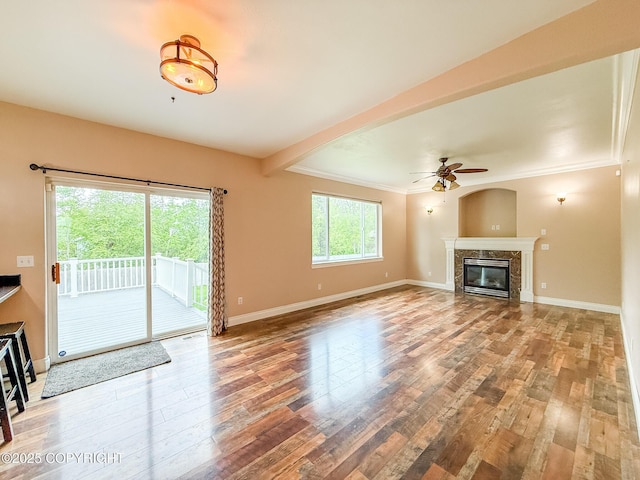 2731 E Tamarak Ave, Wasilla, AK 99654 - unfurnished living room with a fireplace, ceiling fan, wood finished floors, baseboards, and crown molding