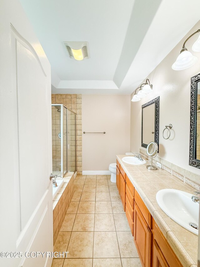 2731 E Tamarak Ave, Wasilla, AK 99654 - bathroom with tiled shower, double vanity, tile patterned flooring, toilet, and a relaxing tiled tub