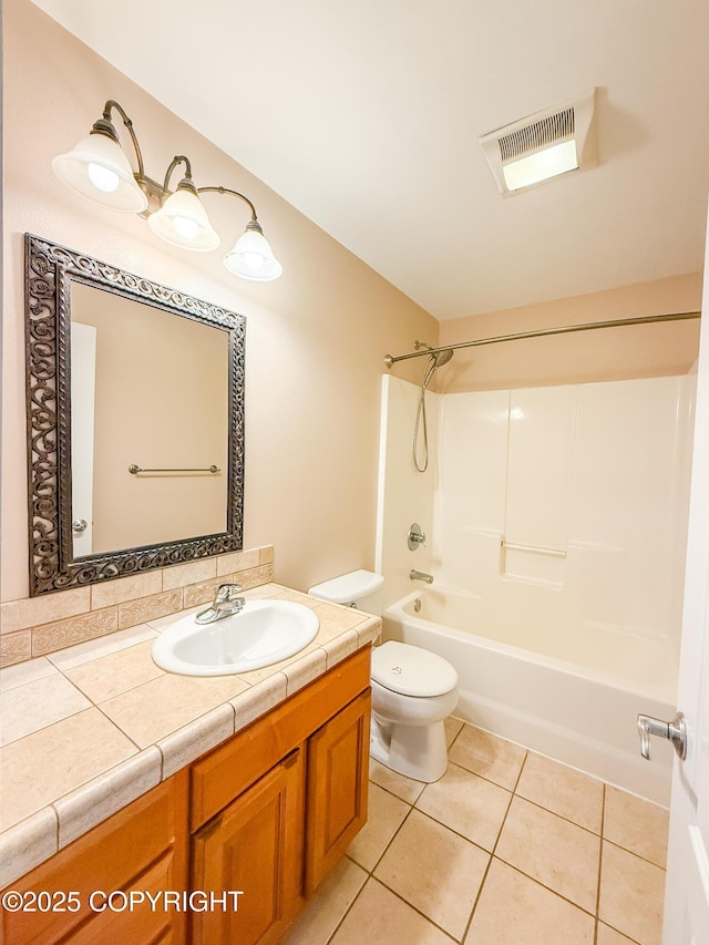 2731 E Tamarak Ave, Wasilla, AK 99654 - bathroom featuring vanity, tile patterned floors, toilet, and bathing tub / shower combination