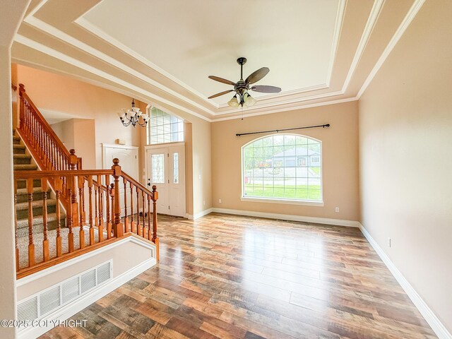2731 E Tamarak Ave, Wasilla, AK 99654 - entrance foyer with a tray ceiling, stairs, wood finished floors, crown molding, and a ceiling fan