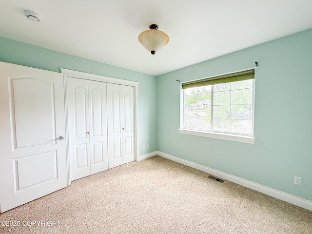 2731 E Tamarak Ave, Wasilla, AK 99654 - unfurnished bedroom featuring a closet, baseboards, and carpet flooring