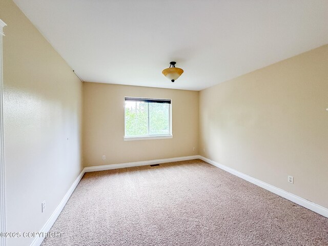 2731 E Tamarak Ave, Wasilla, AK 99654 - unfurnished room featuring carpet and baseboards