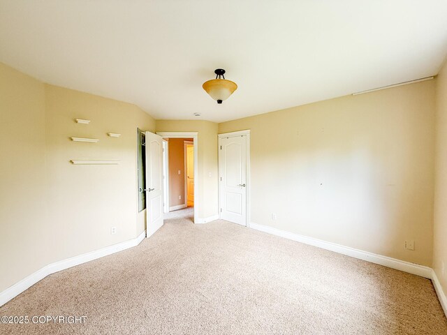 2731 E Tamarak Ave, Wasilla, AK 99654 - unfurnished bedroom with light colored carpet and baseboards