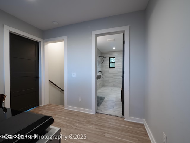 11730 Broadwater Dr, Eagle River, AK 99577 - hallway with an upstairs landing, light wood-style floors, and baseboards