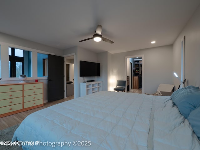 11730 Broadwater Dr, Eagle River, AK 99577 - bedroom with wood finished floors, a walk in closet, a ceiling fan, recessed lighting, and a closet