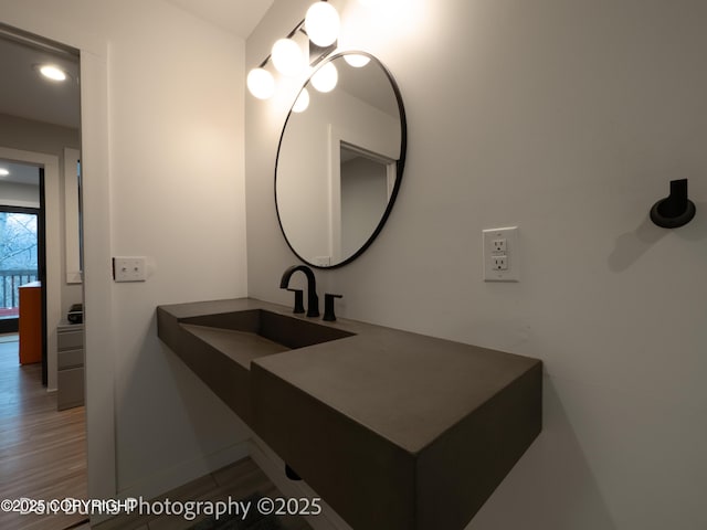 11730 Broadwater Dr, Eagle River, AK 99577 - bathroom featuring a sink, wood finished floors, recessed lighting, and baseboards