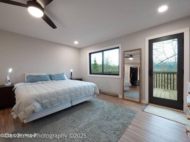 11730 Broadwater Dr, Eagle River, AK 99577 - bedroom with access to outside, wood finished floors, a ceiling fan, recessed lighting, and baseboard heating