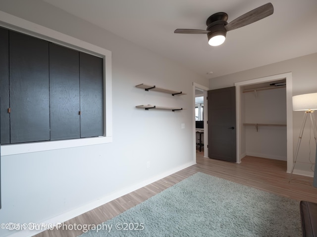 11730 Broadwater Dr, Eagle River, AK 99577 - unfurnished bedroom featuring light wood finished floors, baseboards, a closet, and a ceiling fan