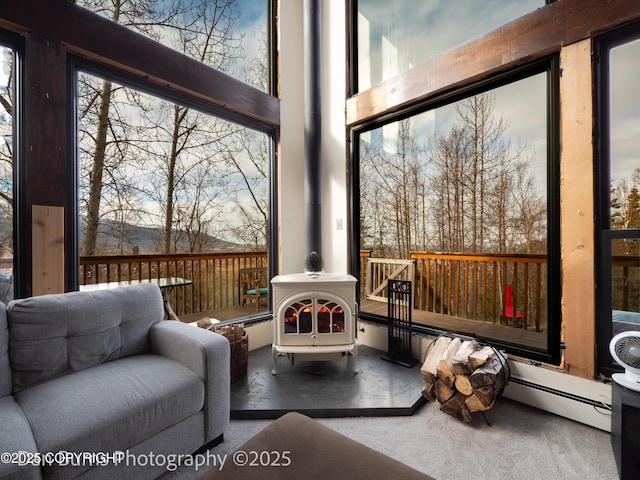 11730 Broadwater Dr, Eagle River, AK 99577 - sunroom featuring a baseboard heating unit and a wood stove