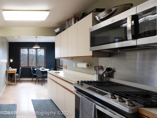 11730 Broadwater Dr, Eagle River, AK 99577 - kitchen featuring stainless steel appliances, a baseboard radiator, white cabinets, and light countertops