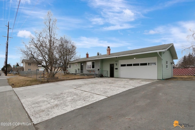 4303 E 3rd Ave, Anchorage, AK 99508 - ranch-style house with an attached garage, driveway, fence, and a chimney
