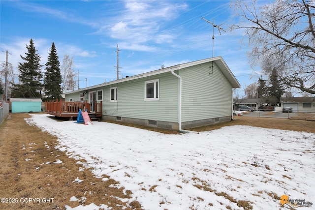 4303 E 3rd Ave, Anchorage, AK 99508 - snow covered back of property with a deck and fence