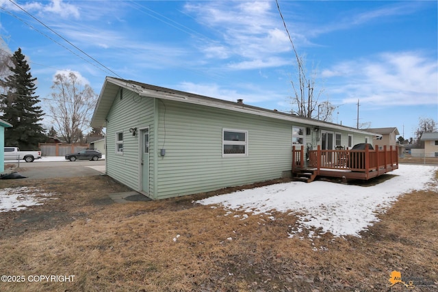 4303 E 3rd Ave, Anchorage, AK 99508 - snow covered property featuring a wooden deck