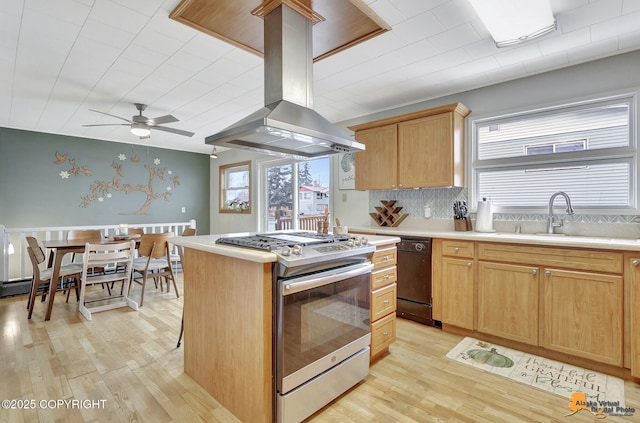 4303 E 3rd Ave, Anchorage, AK 99508 - kitchen featuring island exhaust hood, a ceiling fan, stainless steel range with gas cooktop, light wood finished floors, and a sink