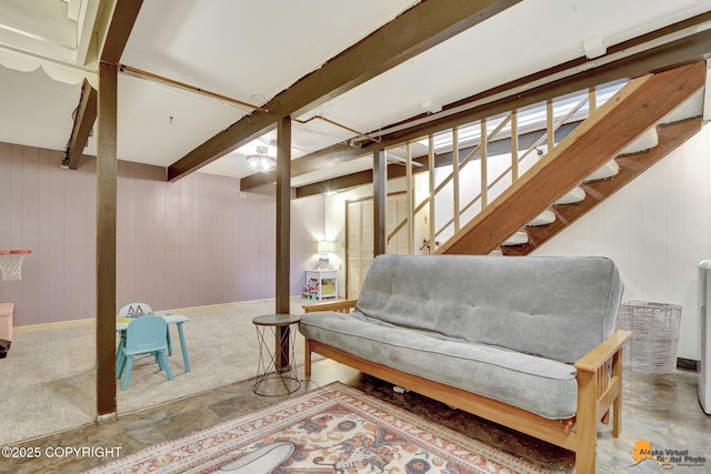 4303 E 3rd Ave, Anchorage, AK 99508 - living area featuring carpet floors, wooden walls, beam ceiling, and stairs
