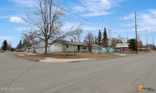 4303 E 3rd Ave, Anchorage, AK 99508 - ranch-style home with a chimney, a residential view, and a fenced front yard