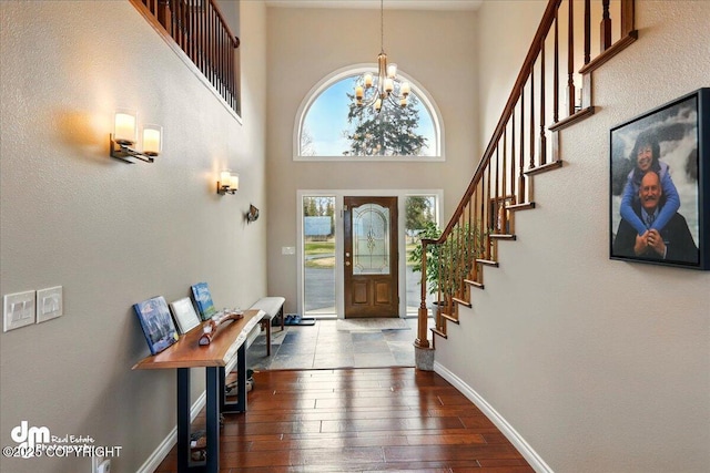 47366 Winridge Ave, Kenai, AK 99611 - entrance foyer with stairway, dark wood finished floors, a chandelier, a towering ceiling, and baseboards