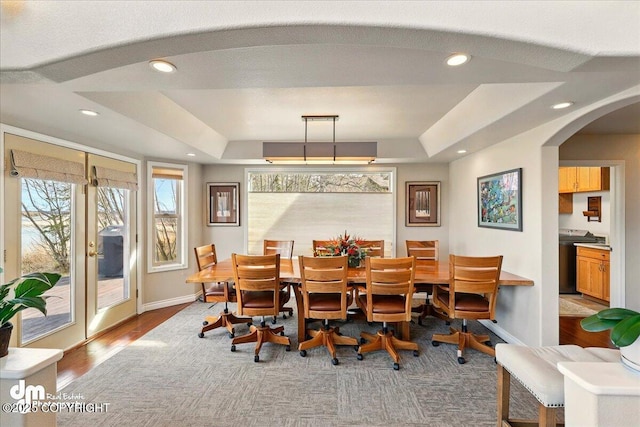 47366 Winridge Ave, Kenai, AK 99611 - dining space featuring arched walkways, a tray ceiling, baseboards, recessed lighting, and wood finished floors