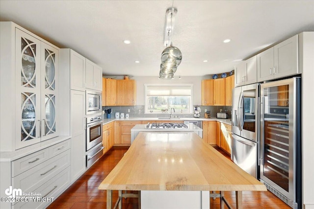 47366 Winridge Ave, Kenai, AK 99611 - kitchen with wine cooler, a warming drawer, a sink, stainless steel appliances, and a center island