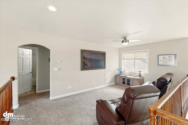 47366 Winridge Ave, Kenai, AK 99611 - carpeted living area featuring arched walkways, ceiling fan, and baseboards