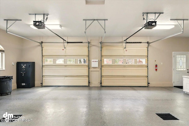 47366 Winridge Ave, Kenai, AK 99611 - garage featuring a garage door opener and baseboards