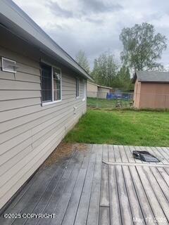 1415 Twining Dr, Anchorage, AK 99504 - wooden deck featuring a yard and an outdoor structure